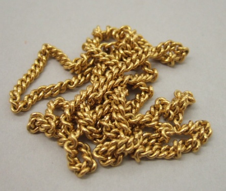 Appraisal: An Oriental gold curb link neckchain with a scroll shaped