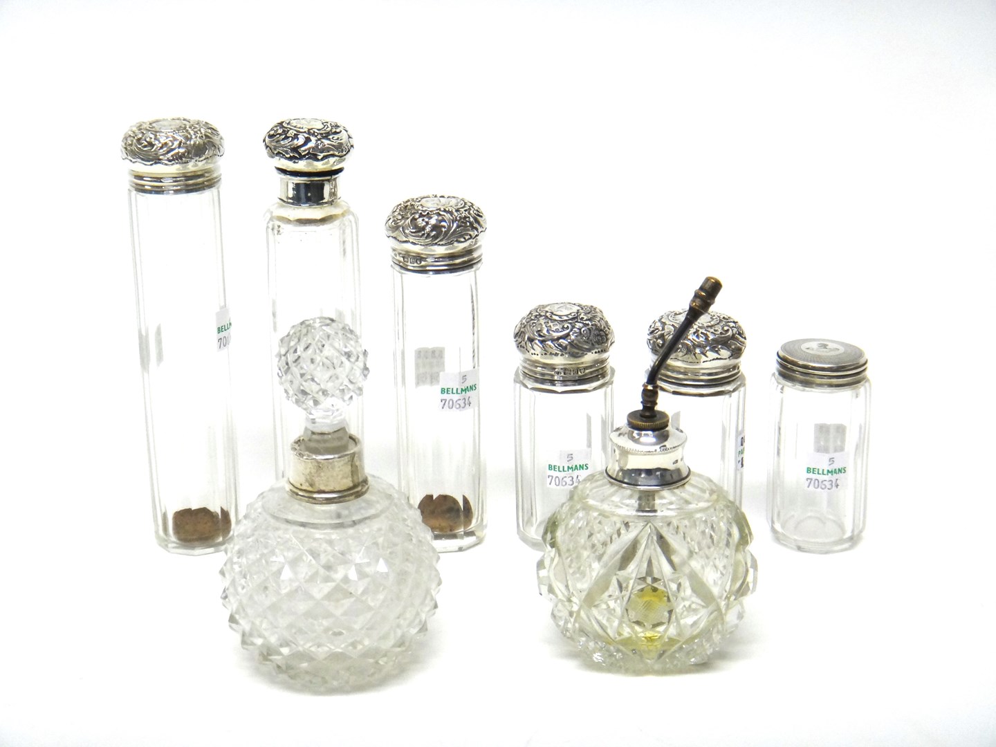 Appraisal: Three silver topped faceted glass toilet bottles and jars London