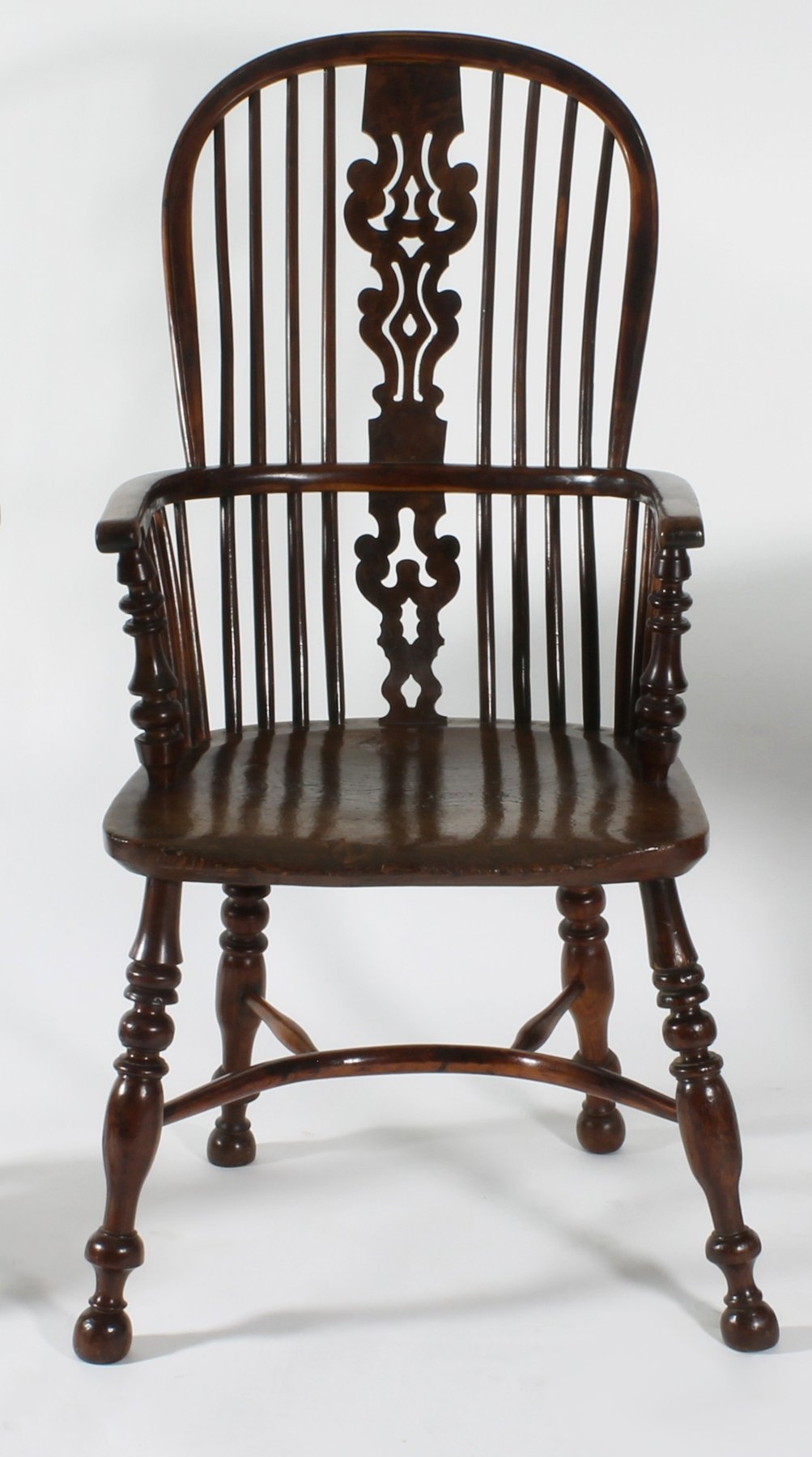 Appraisal: A yew wood and elm high back Windsor armchair with