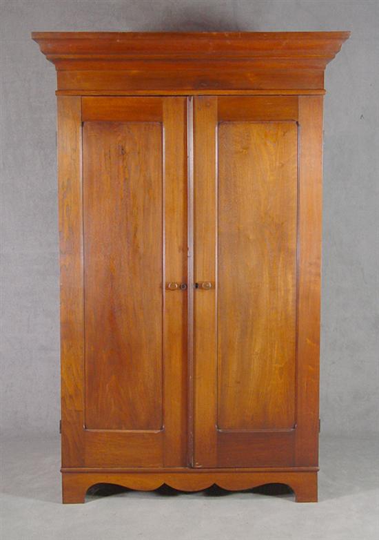 Appraisal: Walnut Empire Wardrobe Circa Ogee molded cornice above paneled ends