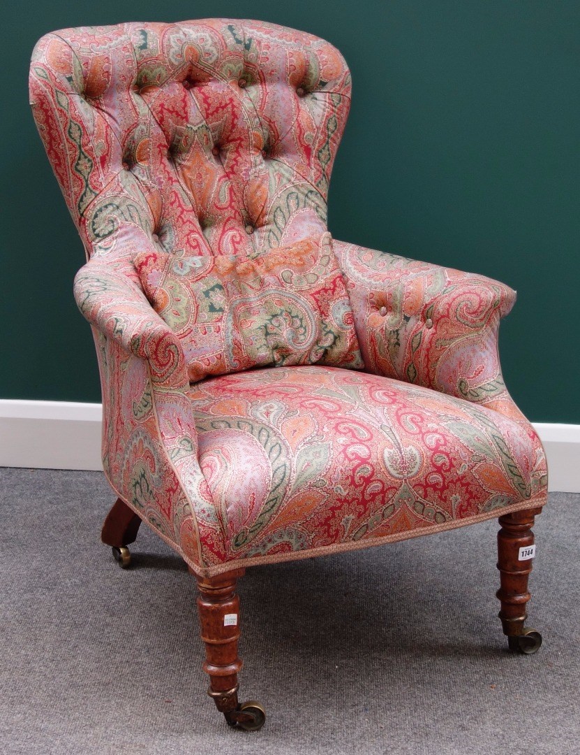 Appraisal: An early Victorian button back easy armchair on turned mahogany