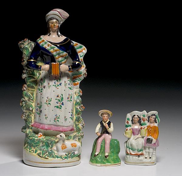 Appraisal: THREE STAFFORDSHIRE FIGURES British th century unmarked of earthenware modeled