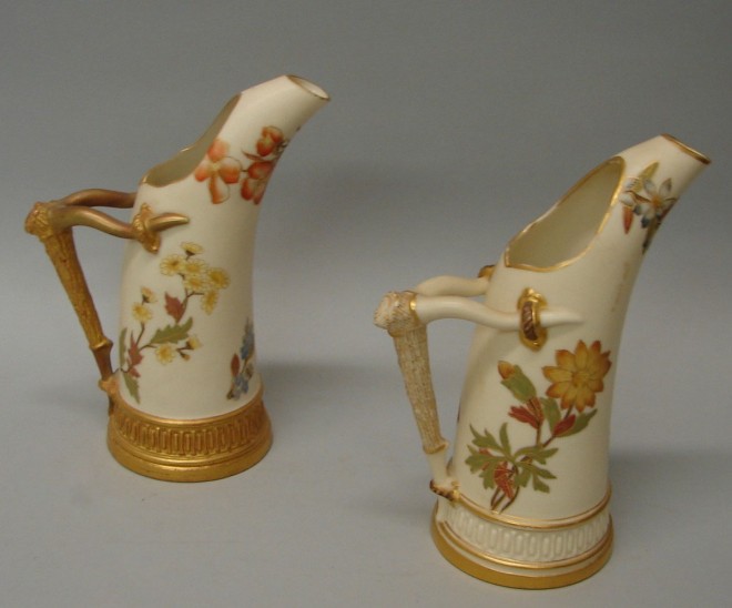 Appraisal: Two complementing Royal Worcester pitchers feature floral motif horn form