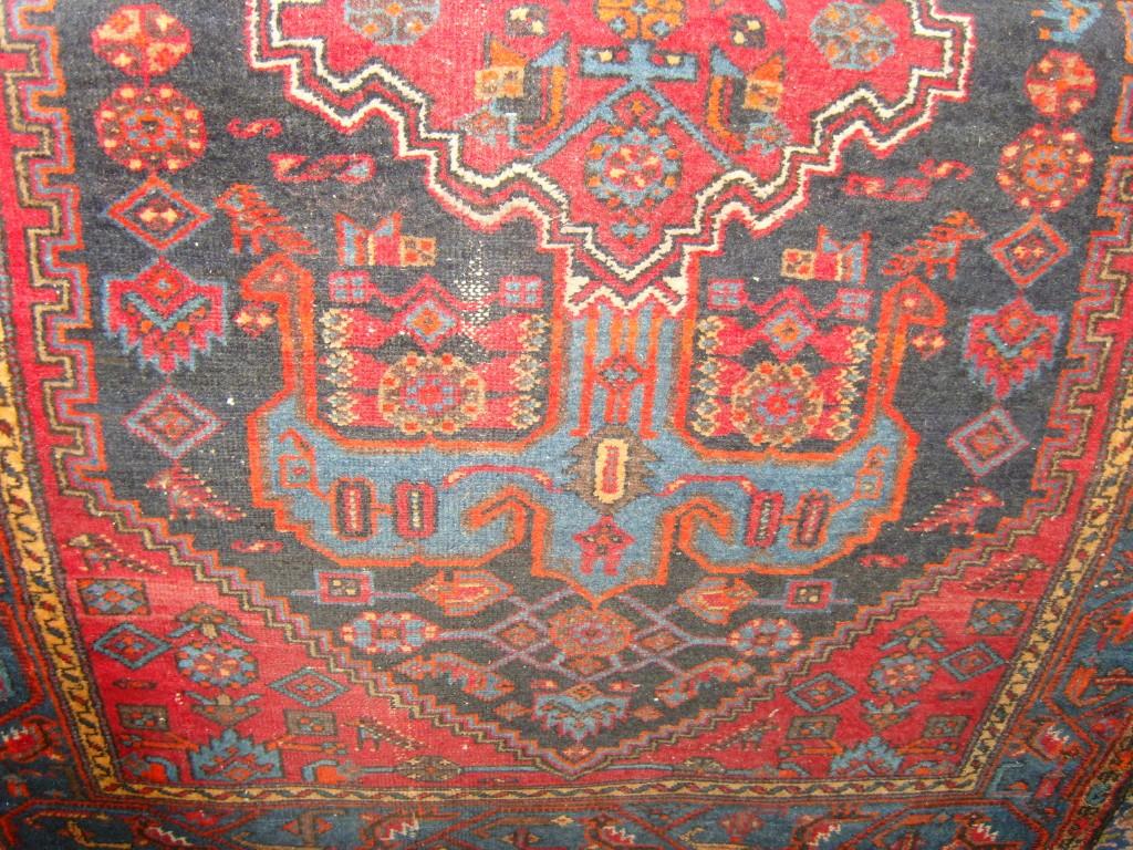 Appraisal: An eastern wool rug with geometric and stylised bird decoration