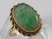 Appraisal: A carat gold carved jade ring jade approx x mm