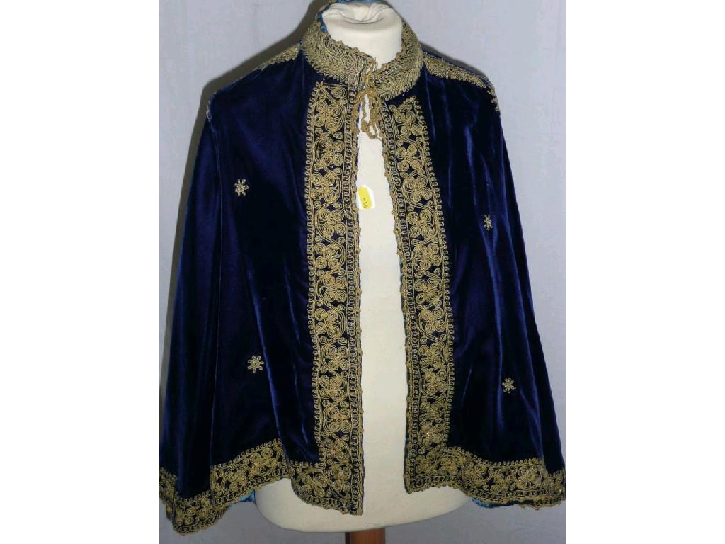 Appraisal: A vintage blue velvet cape with elaborate gold embroidery and