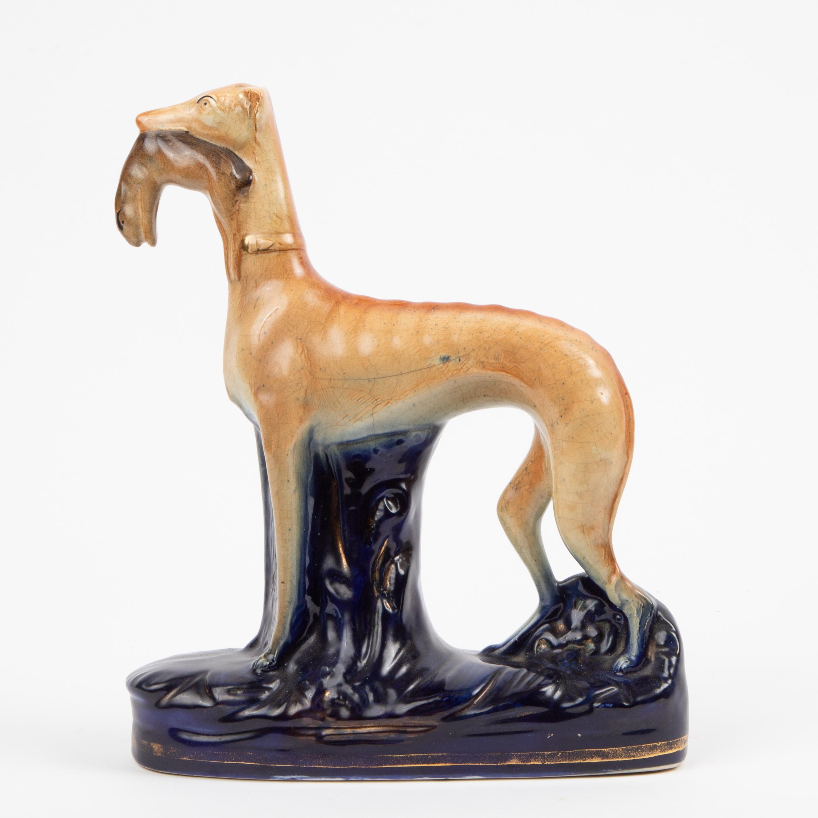 Appraisal: STAFFORDSHIRE GREYHOUND WITH HARE A mid- th c Staffordshire pottery