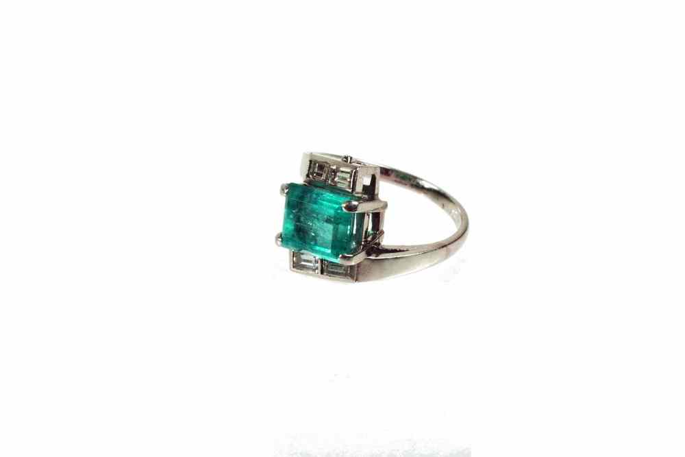 Appraisal: LADY'S RING - Vintage platinum diamond and emerald bypass ring