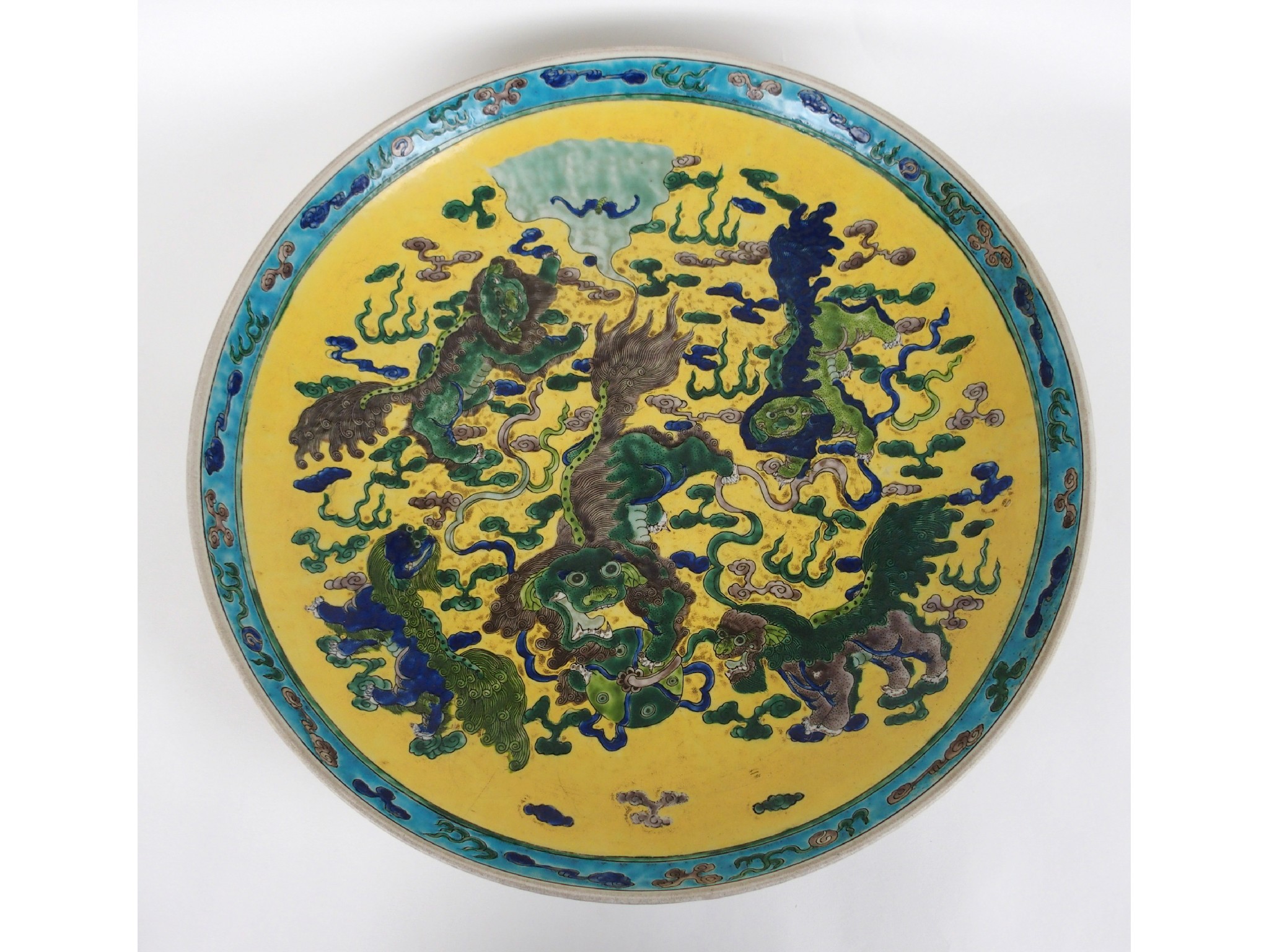 Appraisal: A Chinese famille verte dishpainted with shishi on a yellow