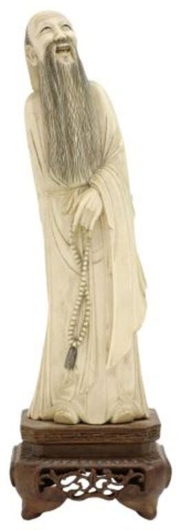 Appraisal: Chinese carved sage figure depicting a bearded man holding prayer