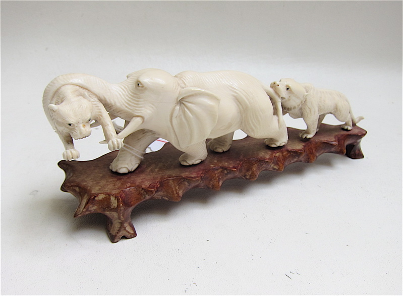 Appraisal: CHINESE CARVED IVORY ELEPHANT AND TIGER SCULPTURE featuring two tigers