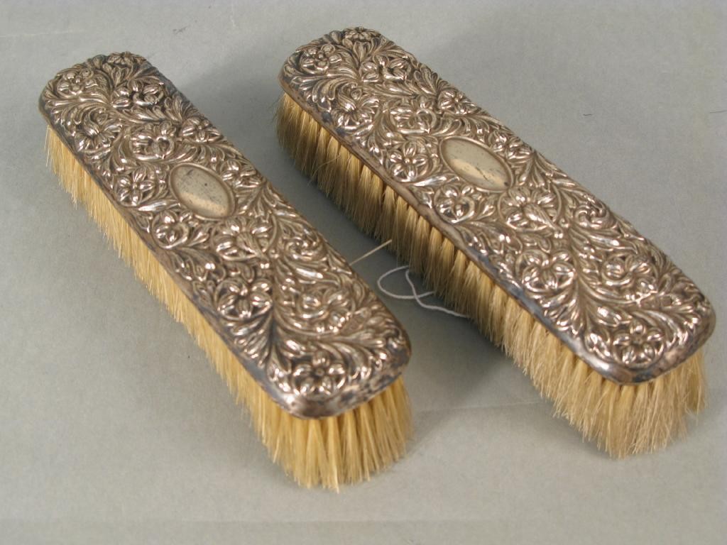 Appraisal: A pair of Edward VII embossed silver clothes brushes Chester