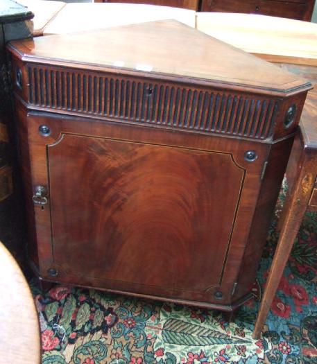 Appraisal: A early th century mahogany corner cupboard the line inlaid