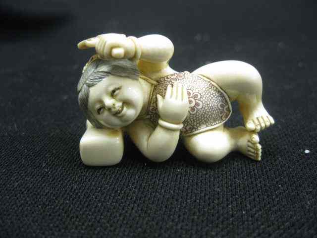 Appraisal: Chinese Carved Ivory Netsuke of Younghappy child resting on a