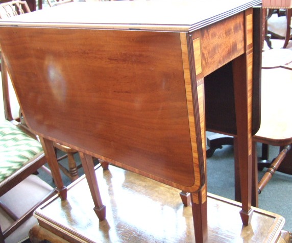 Appraisal: A mahogany and Kingwood banded drop flap table raised on