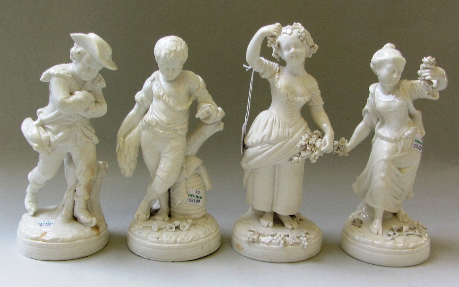 Appraisal: A group of four glazed and undecorated porcelain figures representing