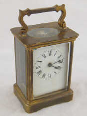 Appraisal: A gilt brass carriage clock with white enamel face