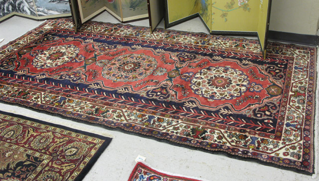 Appraisal: PERSIAN HAMADAN CARPET a three floral medallion design on red