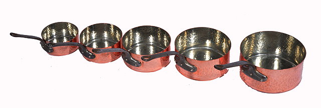 Appraisal: A SET OF FIVE GRADUATED COPPER SAUCEPANS with iron handles