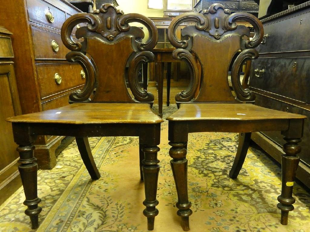 Appraisal: A pair of Victorian mahogany hall chairs the shield shaped