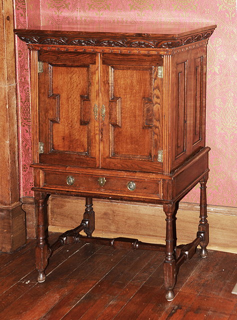 Appraisal: AN OLD OAK CABINET ON STAND with panelled doors and