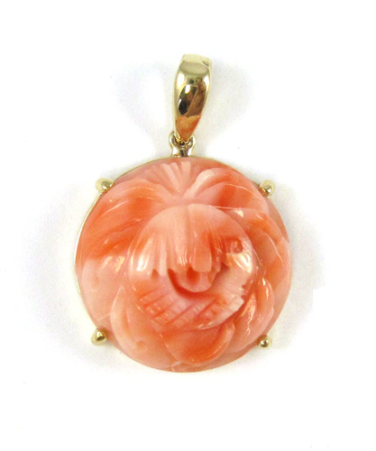 Appraisal: CARVED PINK CORAL PENDANT k yellow gold securing a round