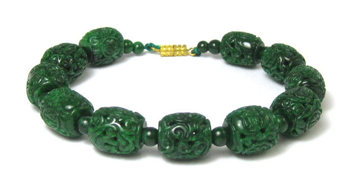 Appraisal: CARVED JADE BEAD BRACELET measuring inches in length and strung