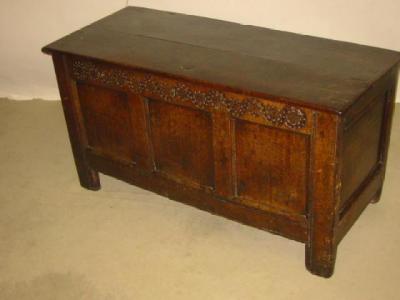 Appraisal: AN OAK COFFER with hinged plank lid the fascia with