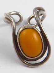 Appraisal: A stylised silver and amber ring hallmarked London maker LL