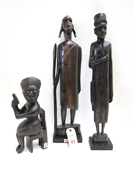 Appraisal: THREE AFRICAN WOOD CARVED FIGURES the first is seated in