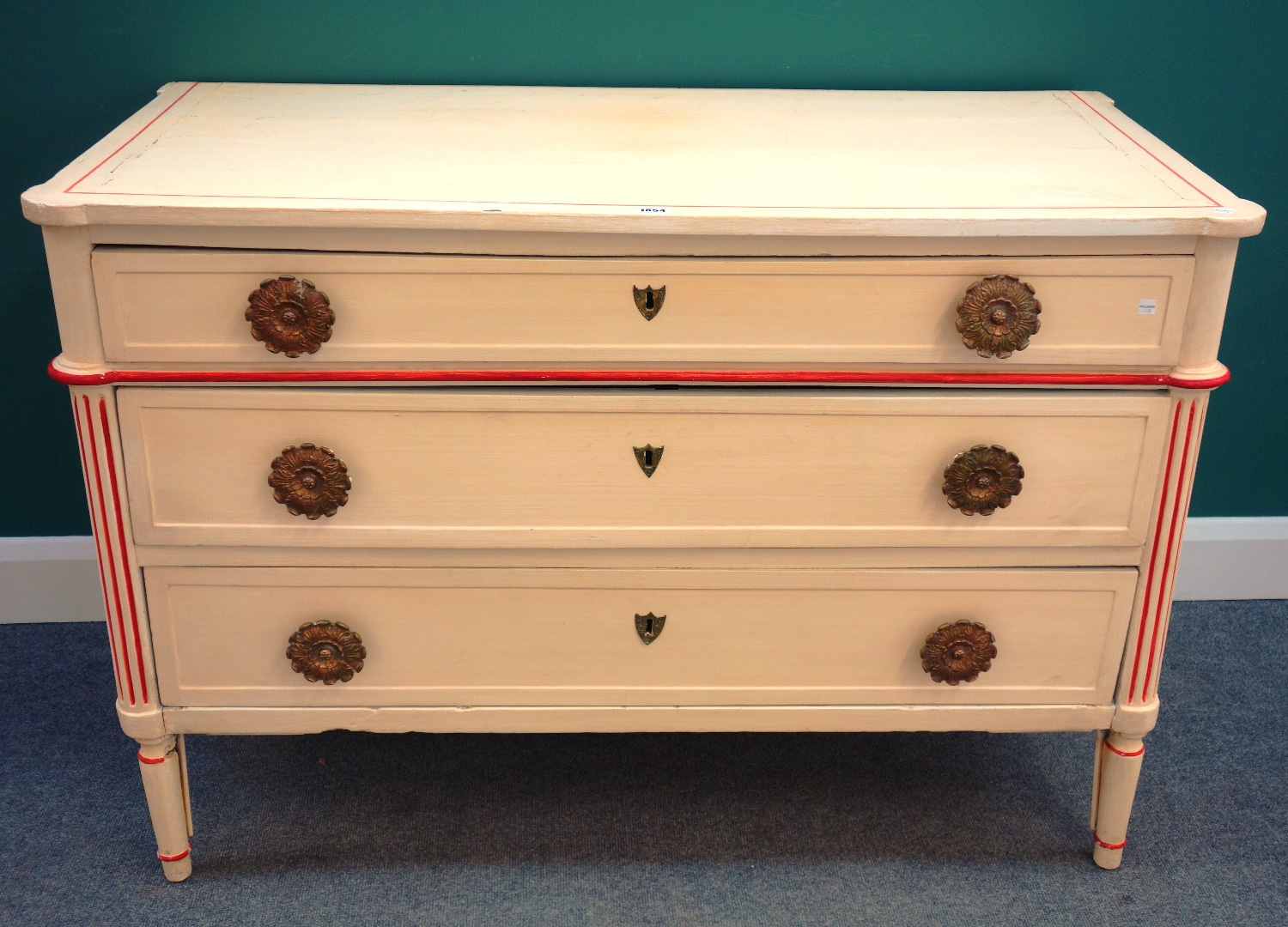 Appraisal: A Louis XVI style cream and red painted three drawer