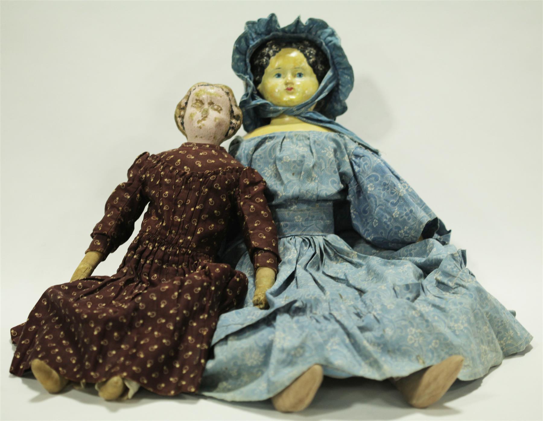 Appraisal: TWO EARLY PAPER MACHE DOLLS Nineteenth century dolls neither are