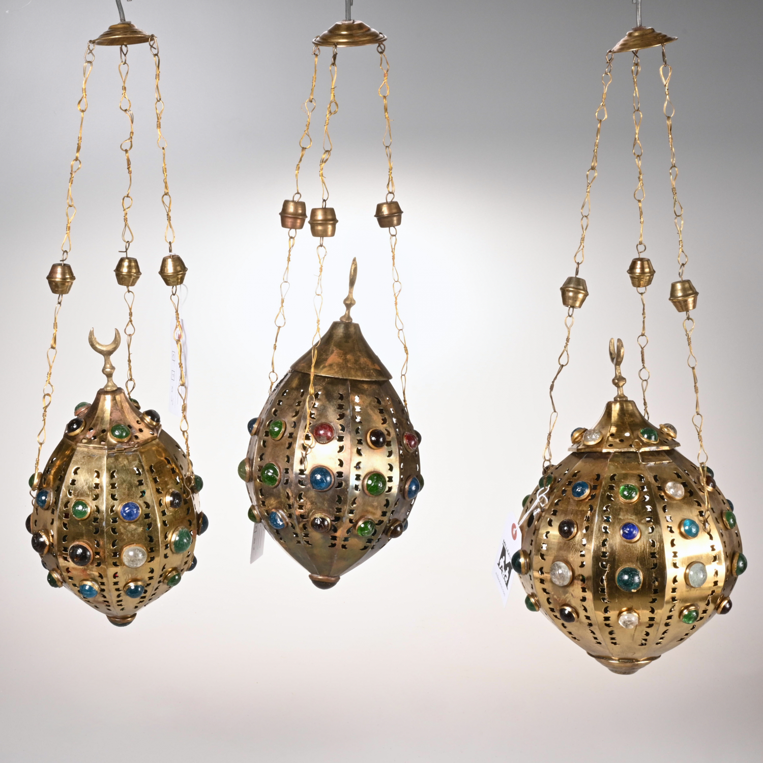 Appraisal: MOROCCAN JEWELED BRASS HANGING LANTERNS th c pierced brass lanterns