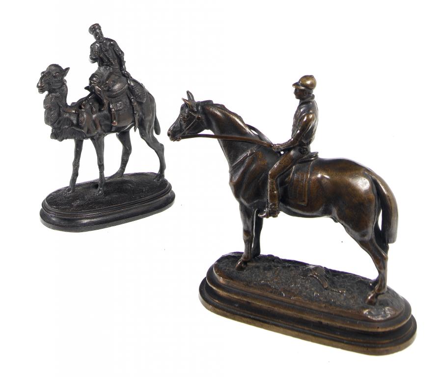 Appraisal: A MINIATURE BRONZE EQUESTRIAN STATUETTE OF A RACEHORSE with jockey