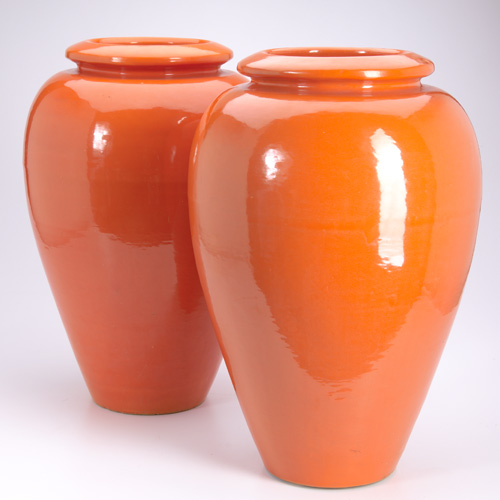 Appraisal: BAUER Pair of tall oil jars in orange glaze Small