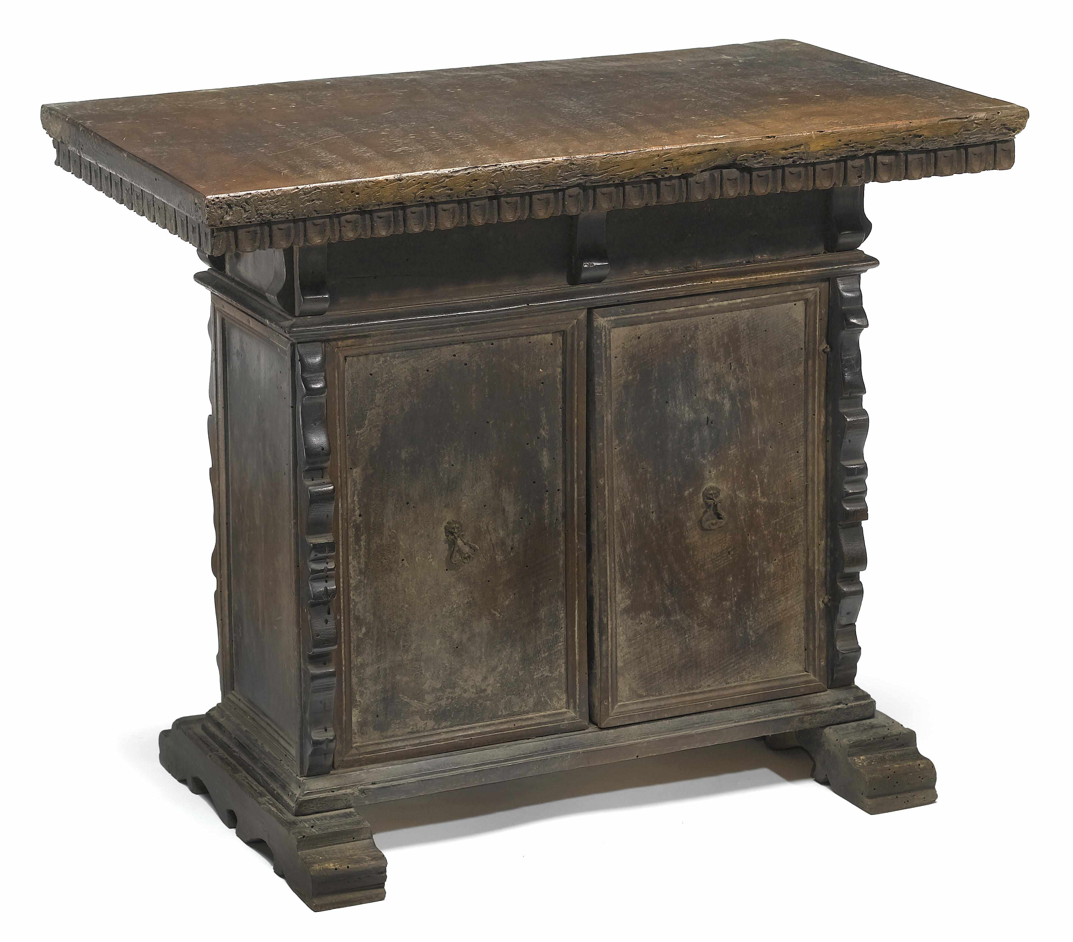 Appraisal: An Italian Baroque style walnut cupboard incorporating antique and later