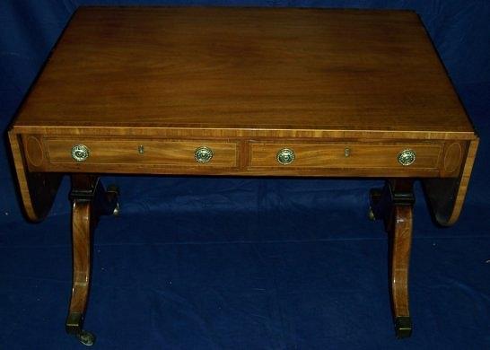 Appraisal: A Regency mahogany and crossbanded sofa table with two frieze