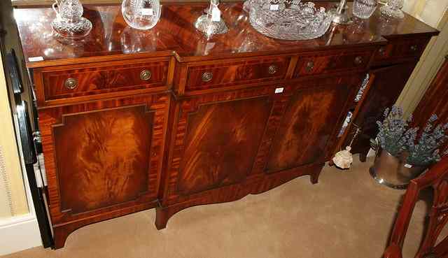 Appraisal: A MAHOGANY BREAK FRONT SIDEBOARD with walnut cross banded top