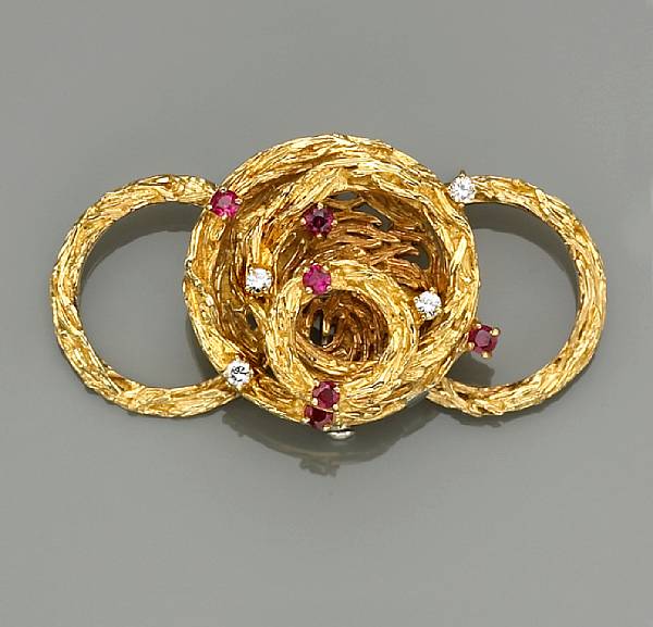 Appraisal: A ruby and diamond articulated and convertible brooch-ring mounted in