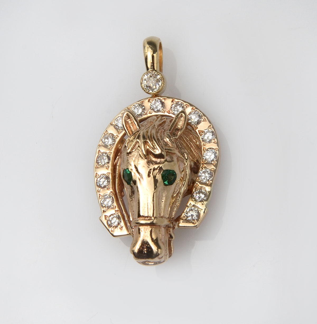 Appraisal: K HORSE PENDANT WITH EMERALDS DIAMONDS Unique D pendant is