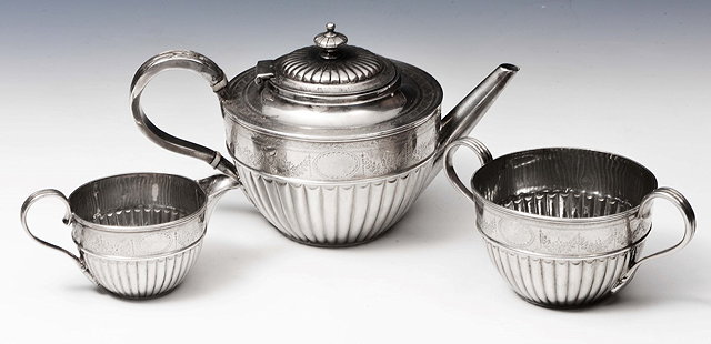 Appraisal: A VICTORIAN SILVER THREE PIECE TEA SET circular teapot with