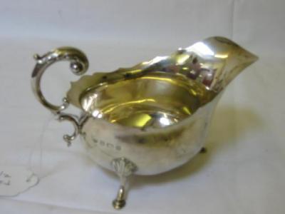 Appraisal: A SAUCE BOAT of bellied oval form with gimped rim