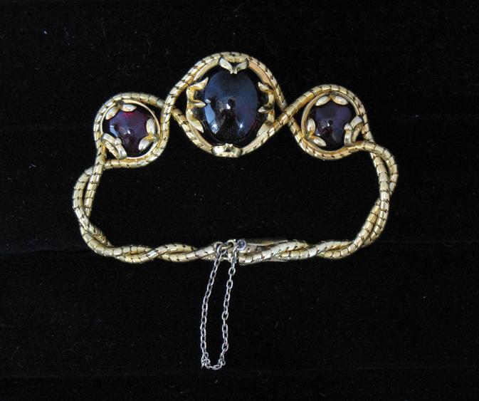 Appraisal: A VICTORIAN GOLD AND GARNET BRACELET of twisted snake-link form