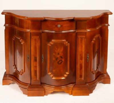 Appraisal: A serpentine fronted side cabinet fitted a central drawer above