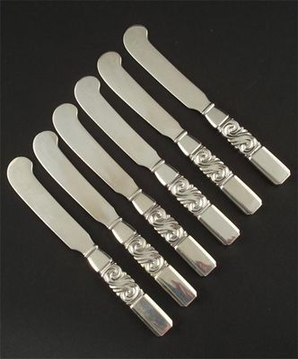 Appraisal: A set of twelve Georg Jensen silver Scroll pattern butter