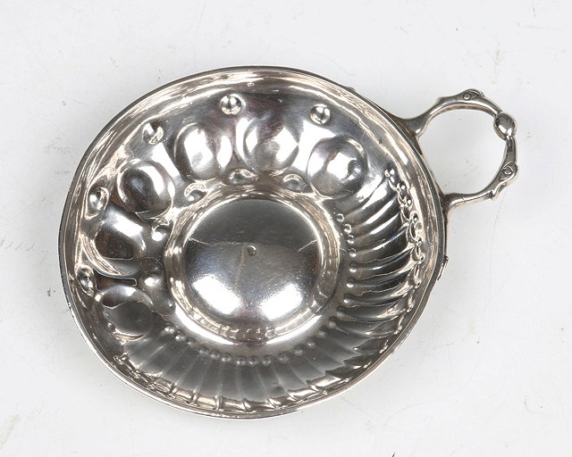 Appraisal: A DUTCH SILVER WINE TASTER circular bowl with chased panels