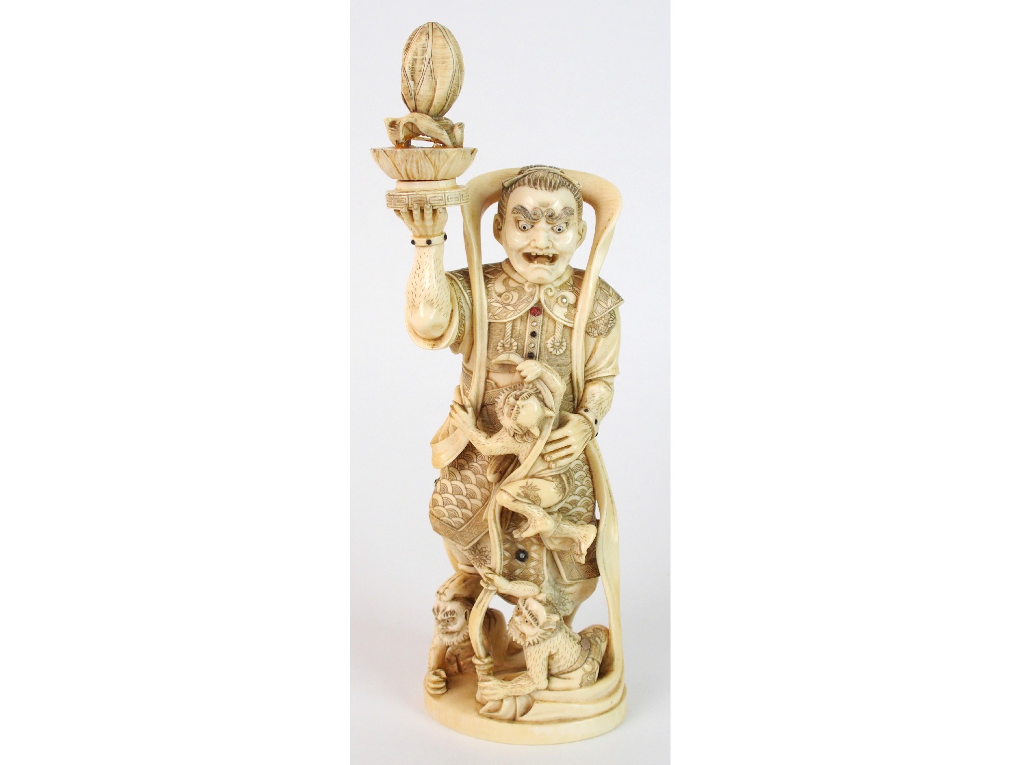 Appraisal: A Japanese ivory okimono of a spiritholding a fruit aloft