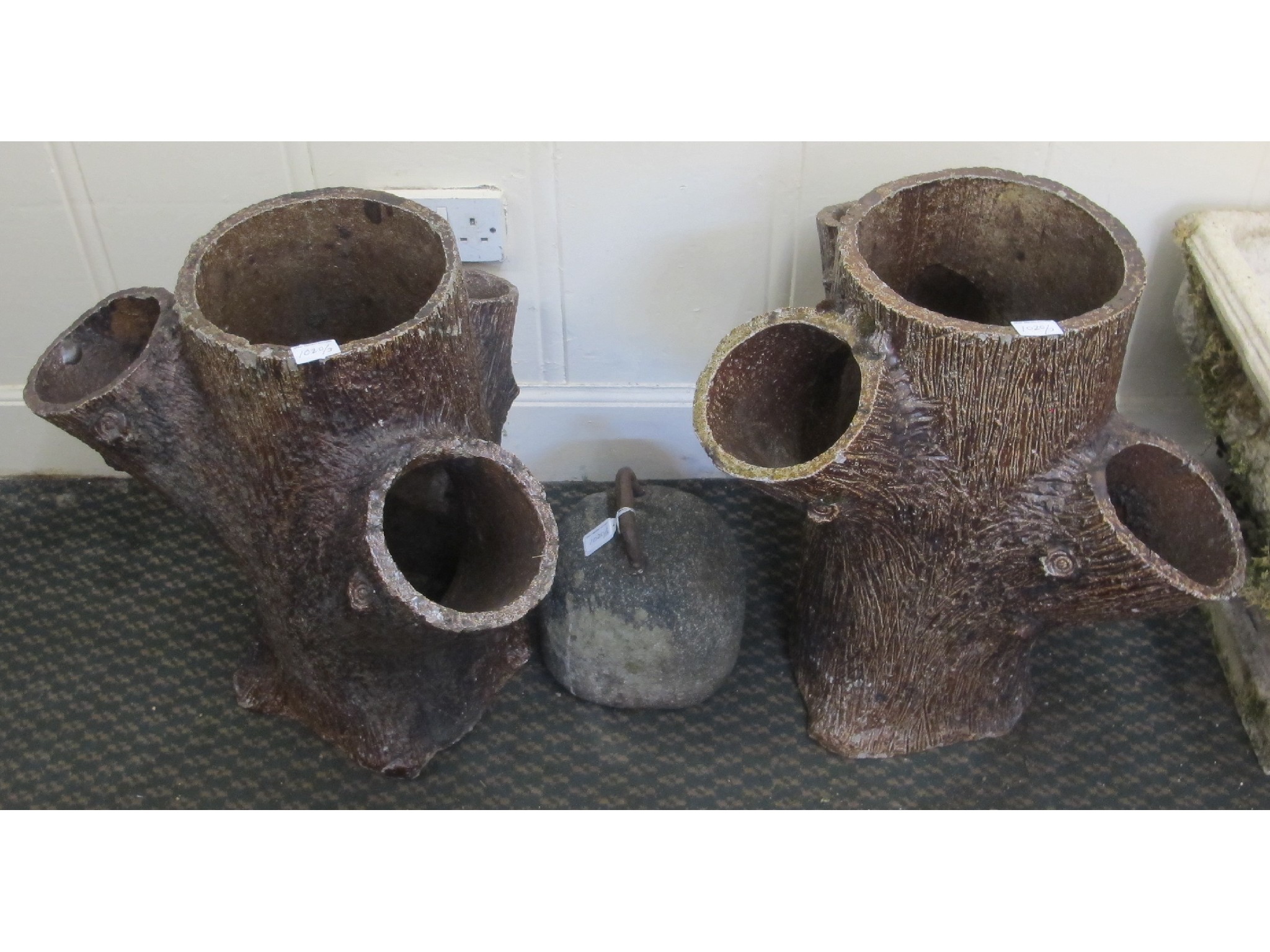 Appraisal: Pair of stoneware tree stump planters and curling stone