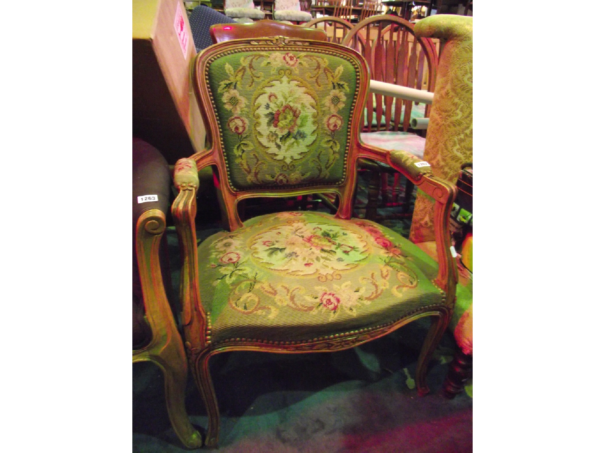 Appraisal: A continental open armchair with floral tapestry upholstered serpentine seat