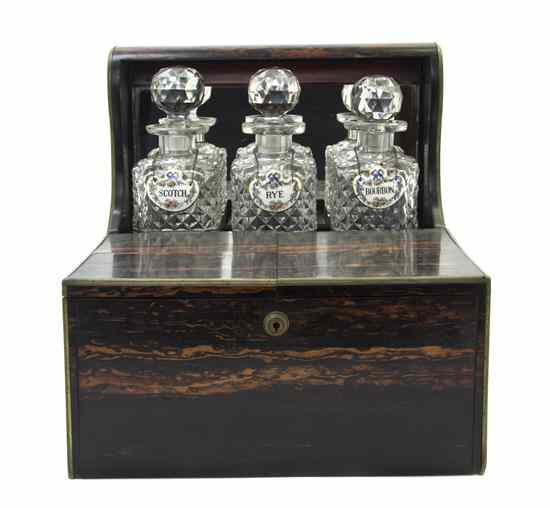 Appraisal: An English Brass Bound Calamander Tantalus set with three glass